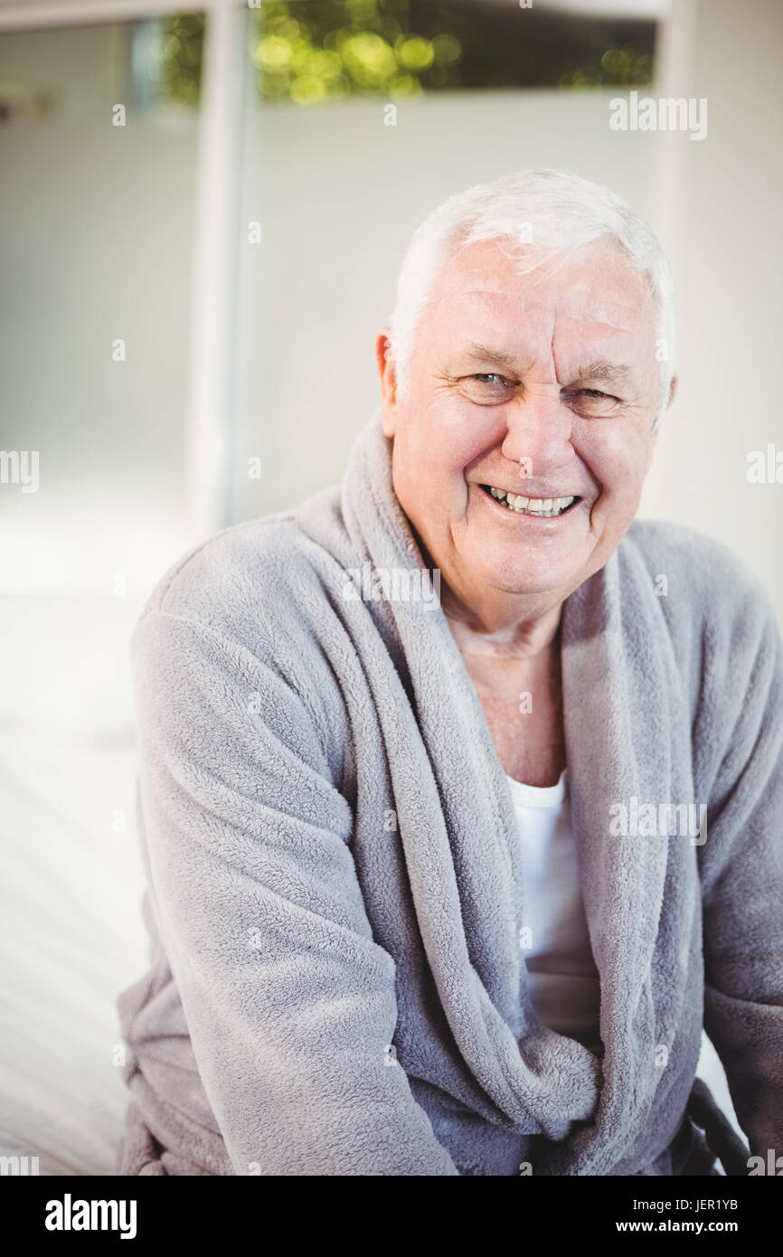 Smiling senior man in bedroom at home Stock Photo
