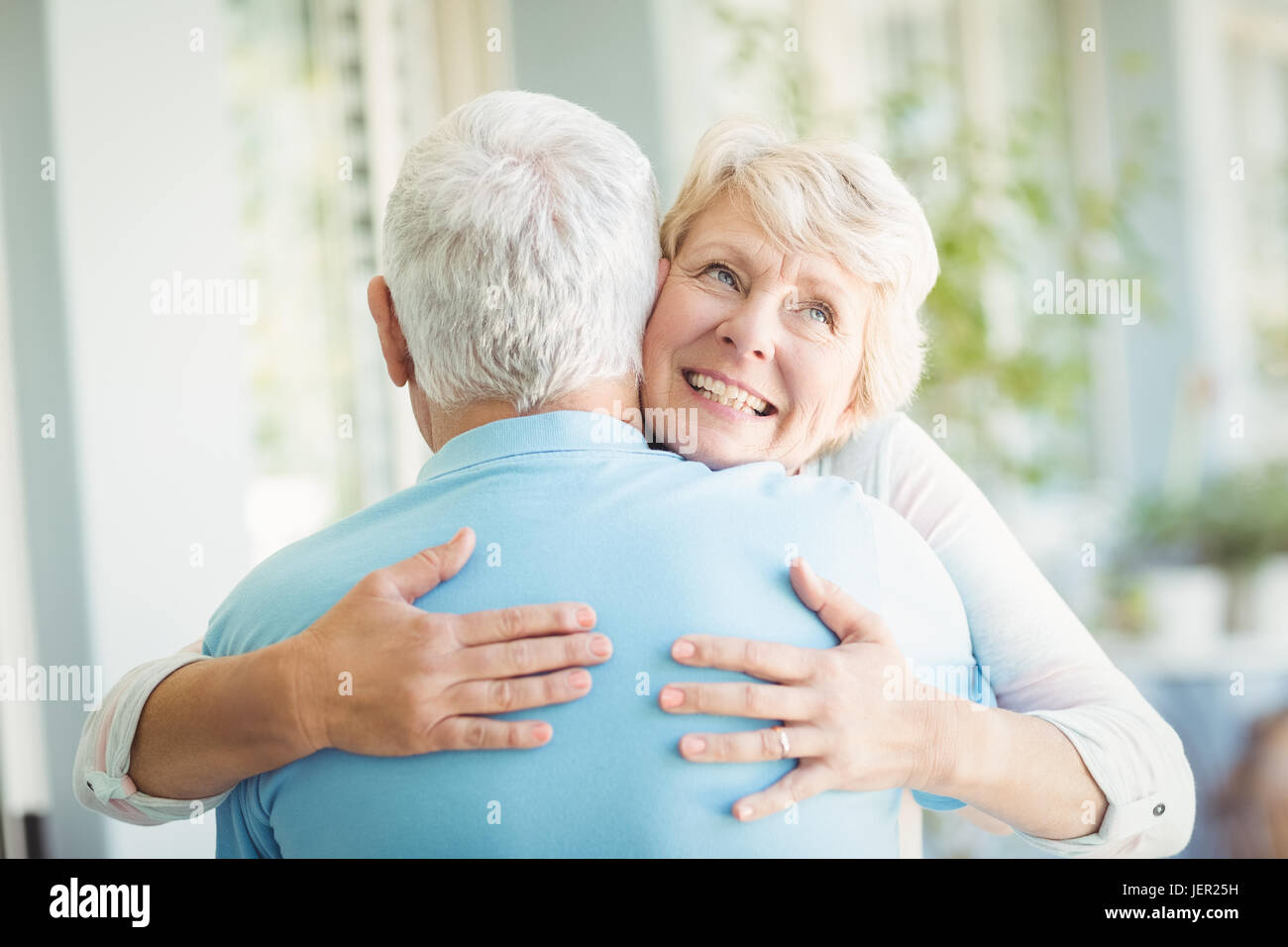 Happy senior woman hugging her husband Stock Photo - Alamy