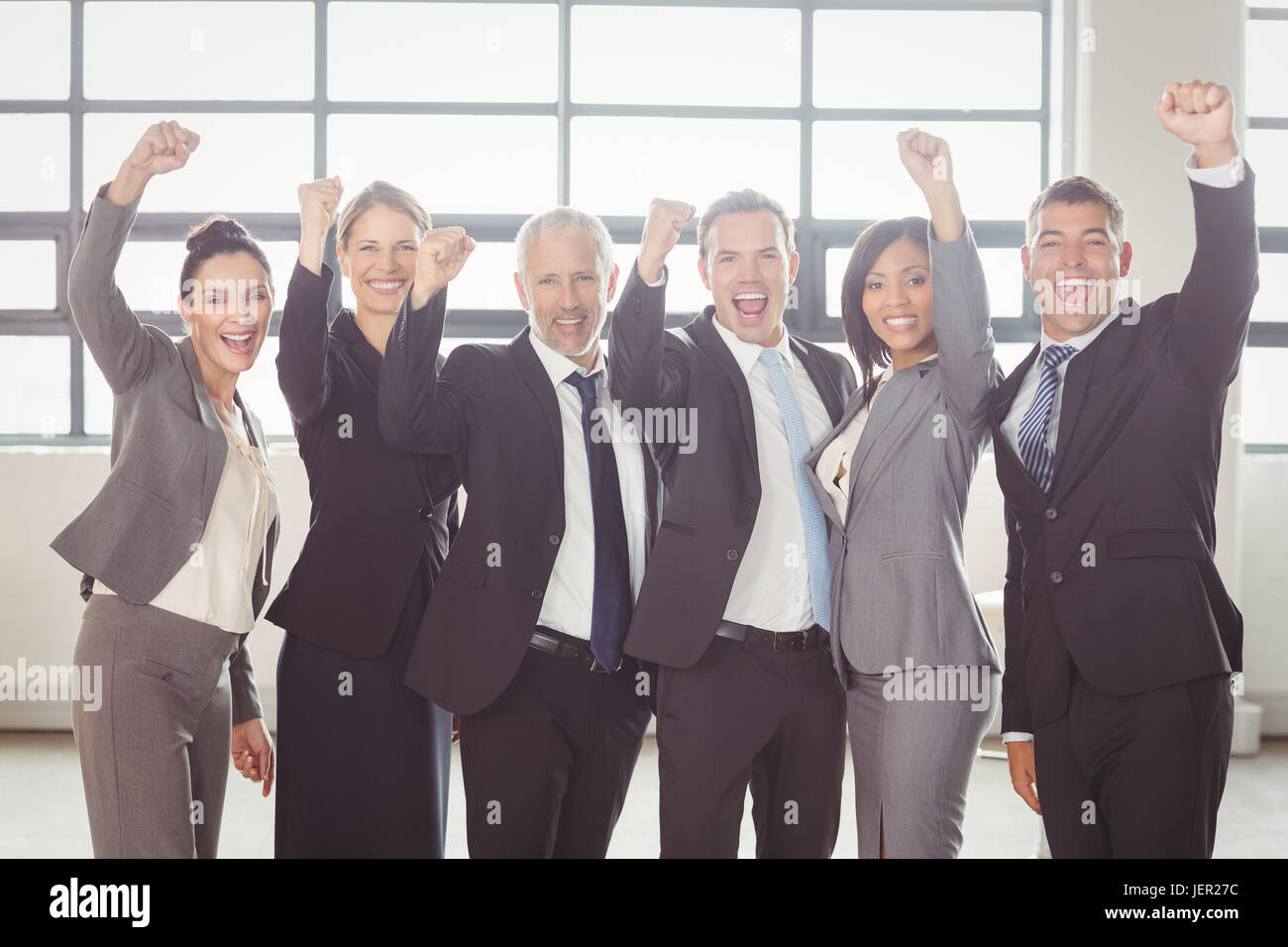 Businessman cheering with clenched fist Stock Photo - Alamy