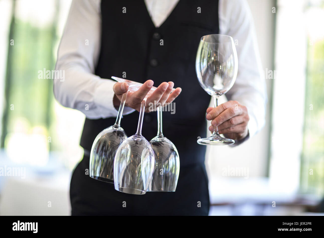 Waiter holding wine hi-res stock photography and images - Alamy