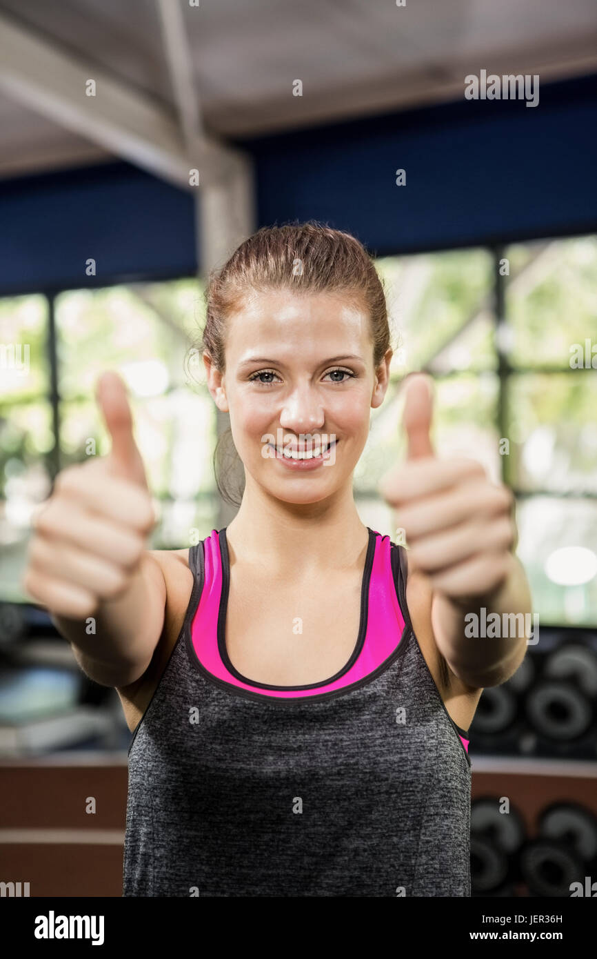 Happy woman showing her thumbs up Stock Photo - Alamy