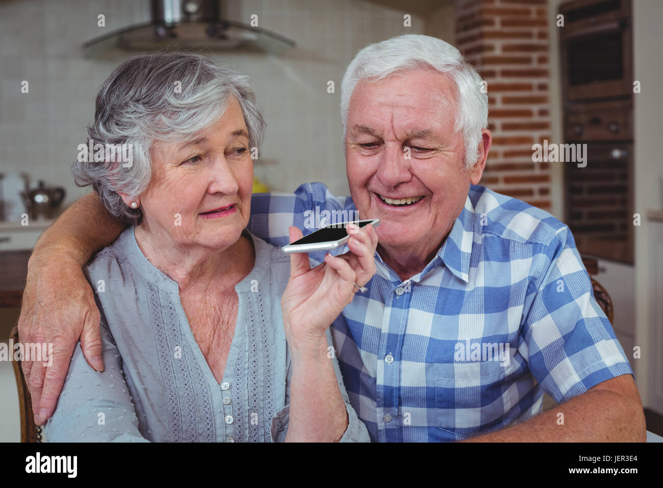 Happy senior couple talking on mobile phone Stock Photo