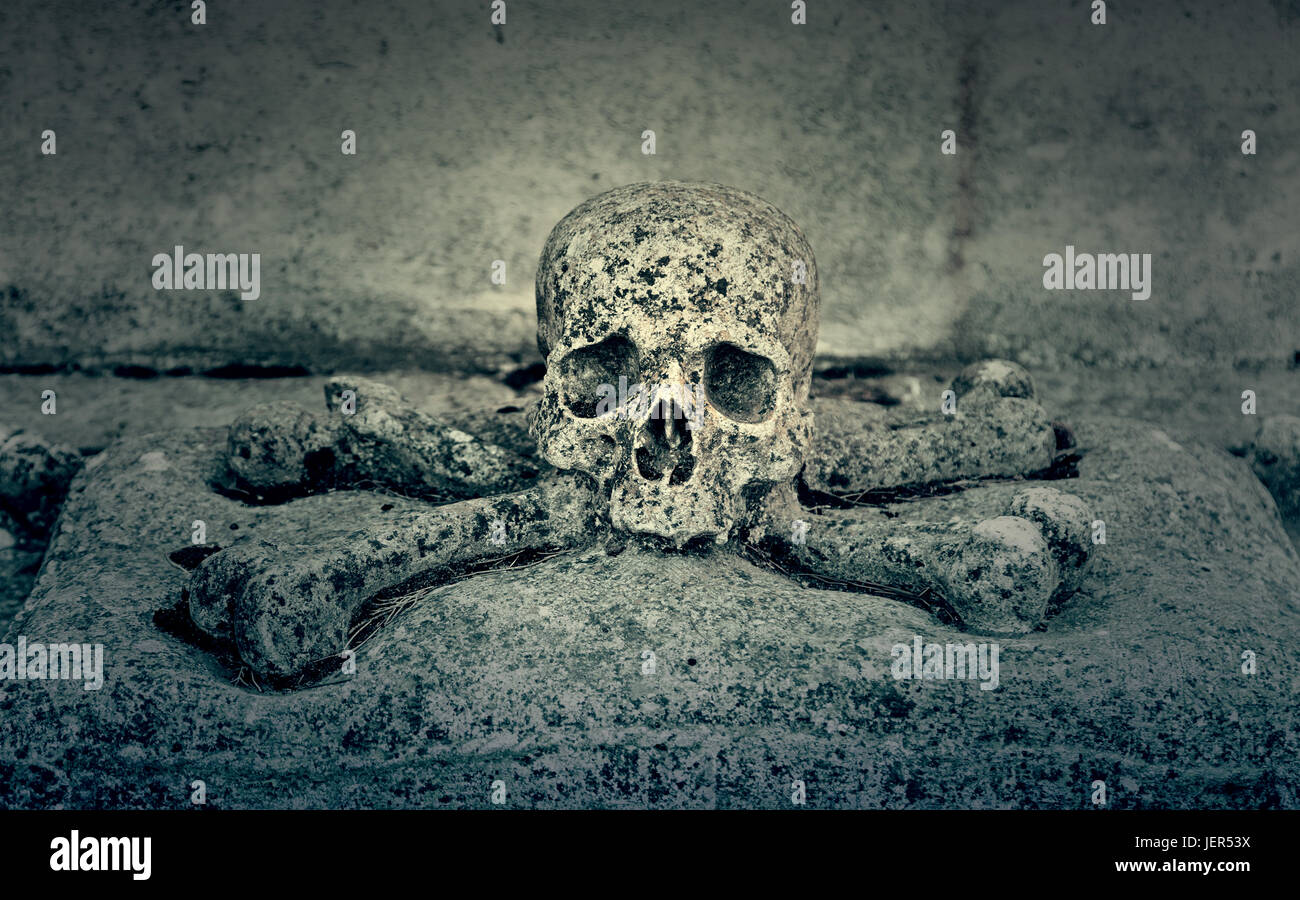 Stone skull, detail of an ancient cemetery, death Stock Photo