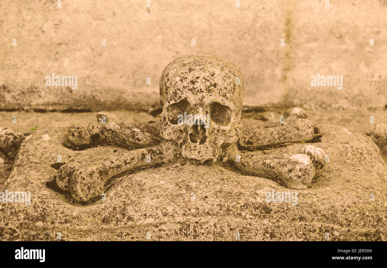 Stone skull, detail of an ancient cemetery, death Stock Photo