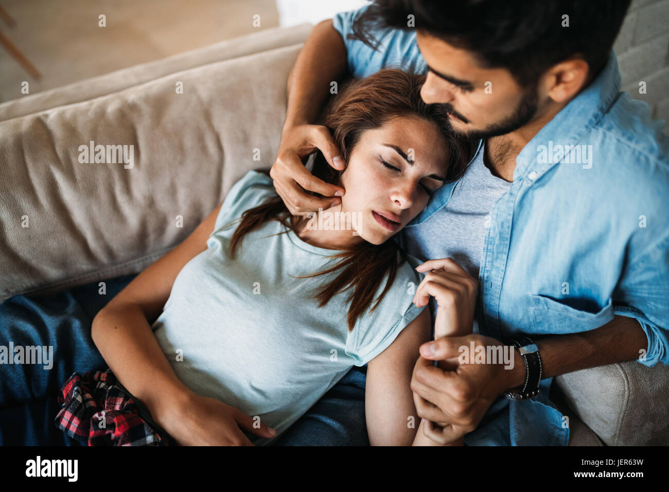 Pretty young girl lying on lap of her handsome boyfriend Stock Photo
