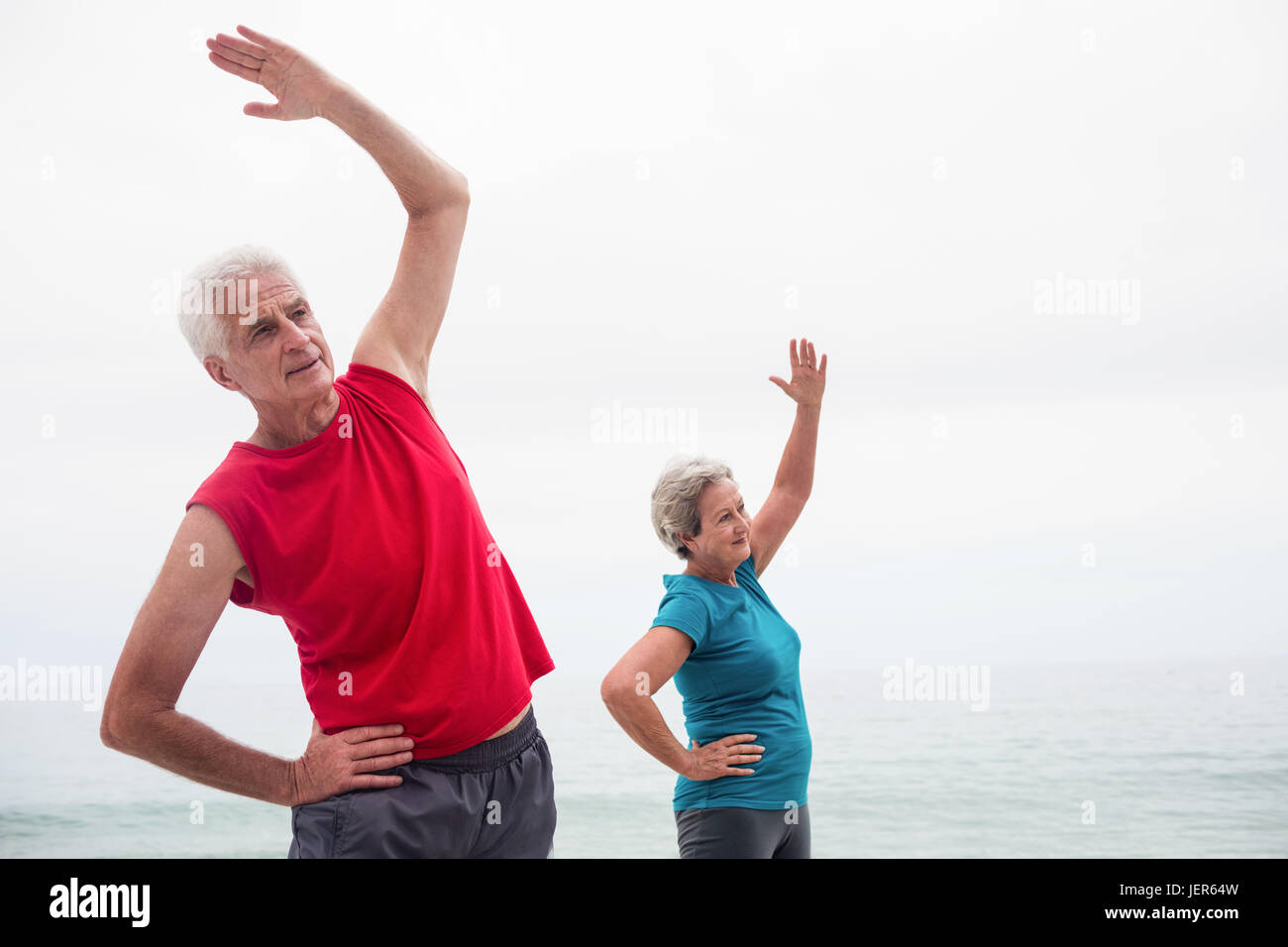 Senior couple performing stretching exercise Stock Photo - Alamy