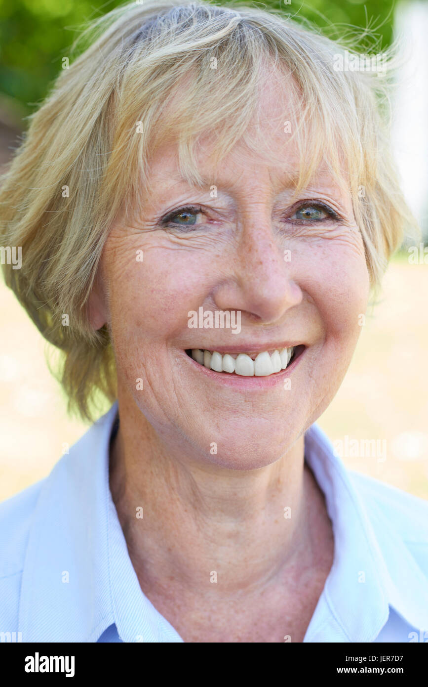Outdoor Head And Shoulders Portrait Of Senior Woman Stock Photo