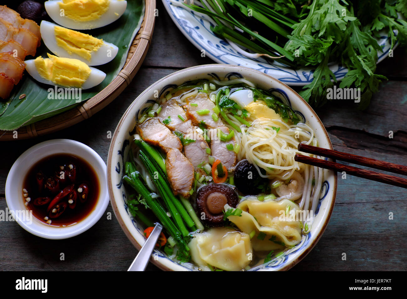 Homemade Vietnam food, egg noodle soup with wontons, colorful food ingredient for this eating as egg, pork, broth, shallot, bean sprout,  vegetable Stock Photo