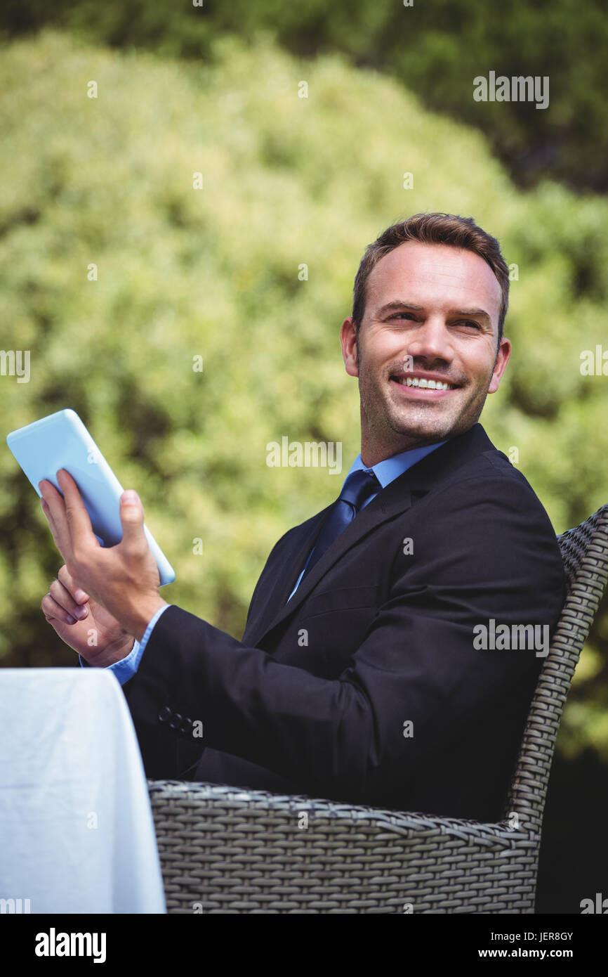 Smiling businessman using tablet Stock Photo - Alamy