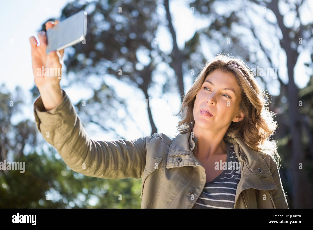 Happy woman taking selfie Stock Photo - Alamy