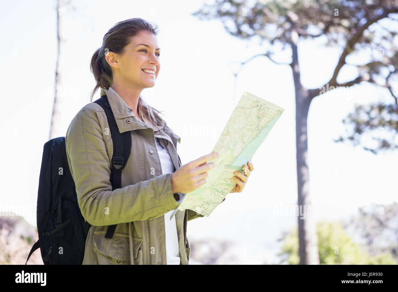 Smiling woman checking map hi-res stock photography and images - Alamy