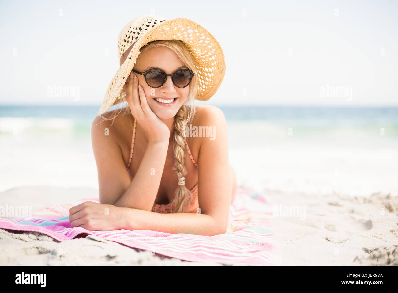 Happy woman lying on the beach Stock Photo - Alamy