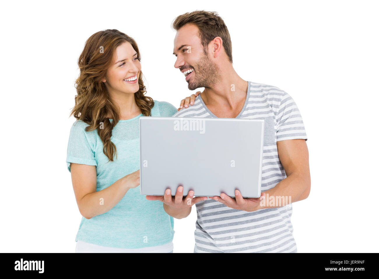 Happy young couple using laptop Stock Photo - Alamy
