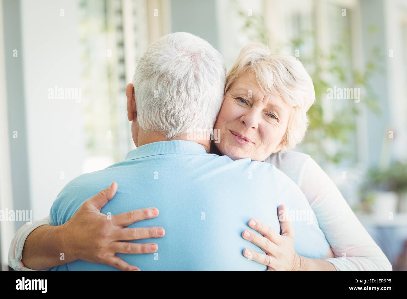 Portrait of senior woman hugging her husband Stock Photo - Alamy
