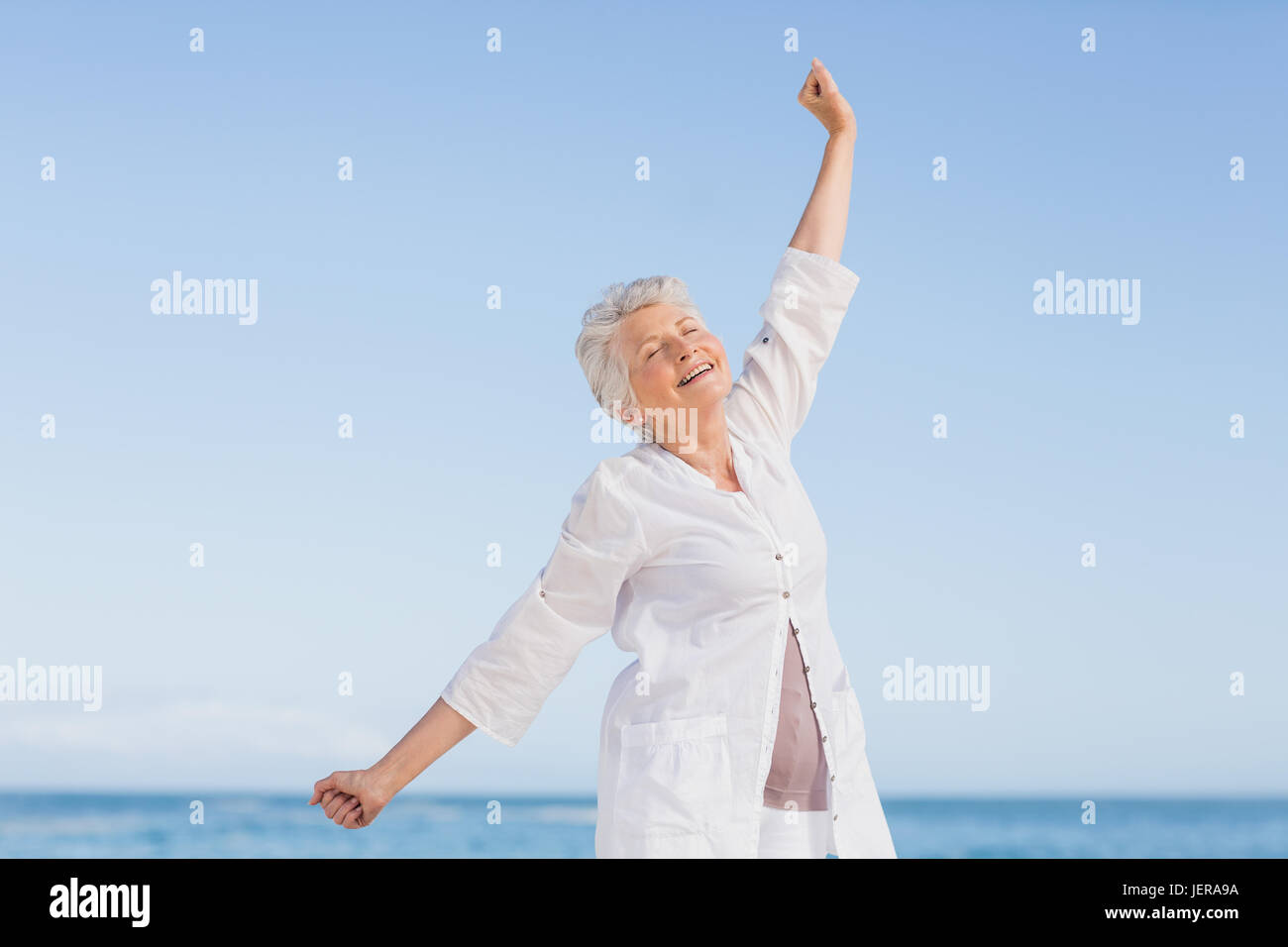 Senior woman relaxing on the beach Stock Photo - Alamy