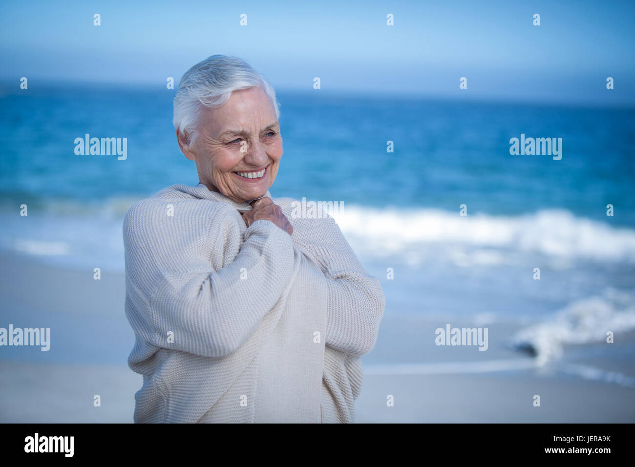 Senior woman relaxing at the beach Stock Photo - Alamy