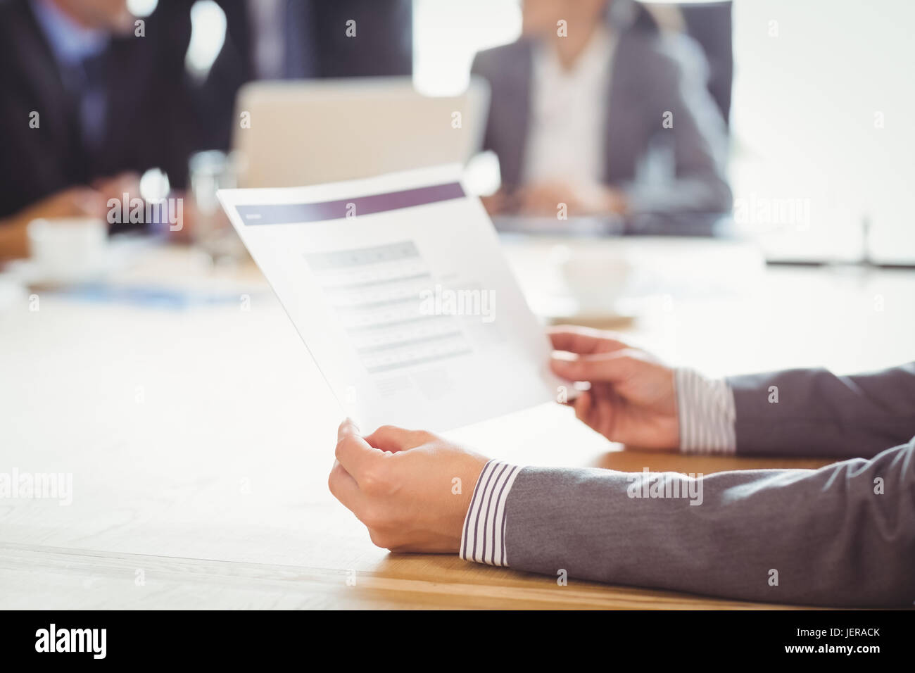 Businesswoman reading a report Stock Photo - Alamy