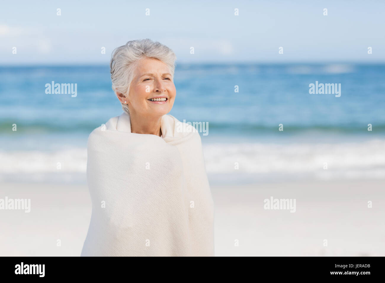 Senior woman relaxing on the beach Stock Photo - Alamy