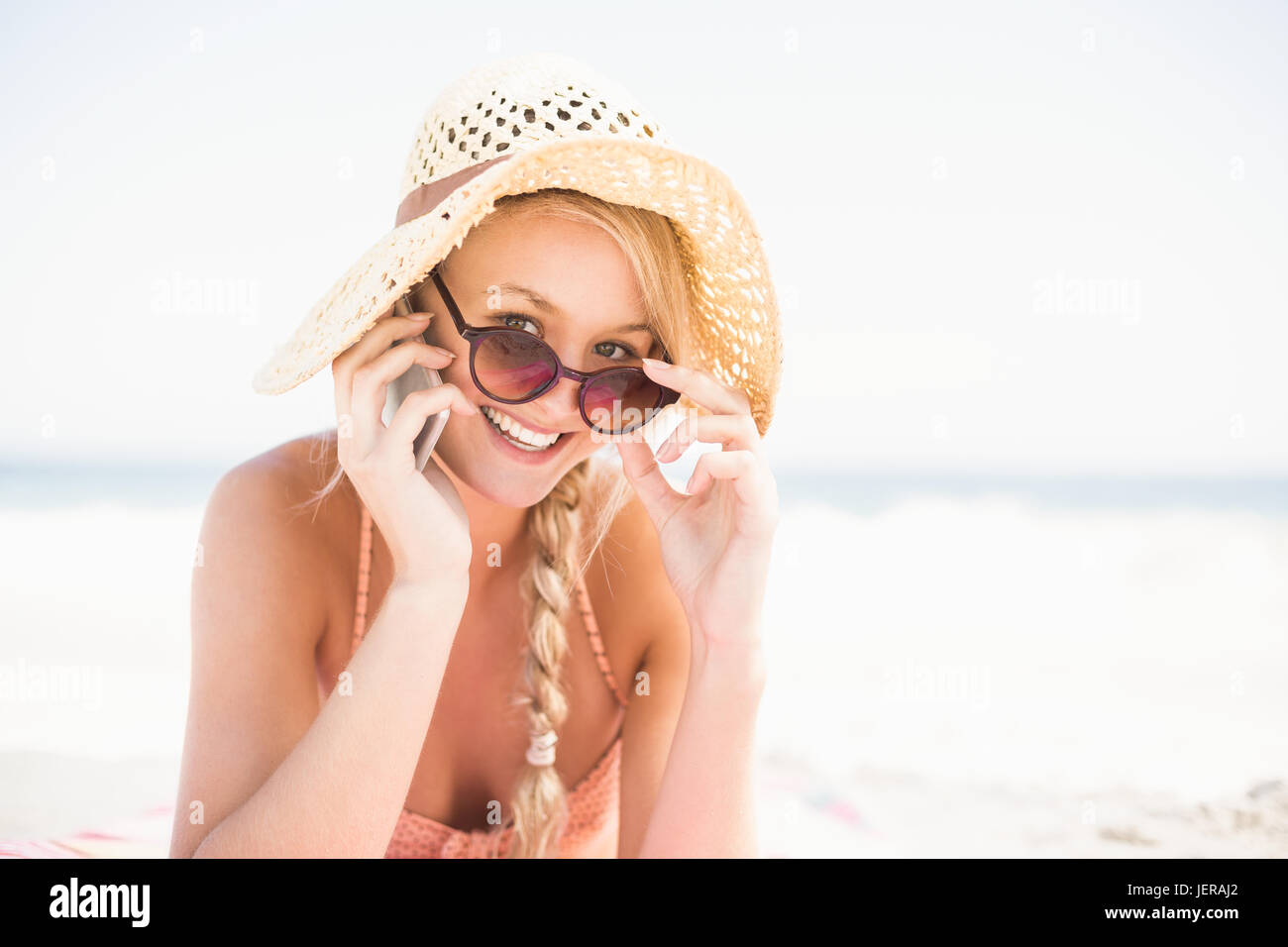 Portrait of happy woman lying on the beach Stock Photo - Alamy