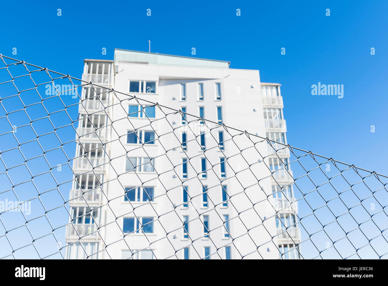 Building behind chain link fence Stock Photo - Alamy