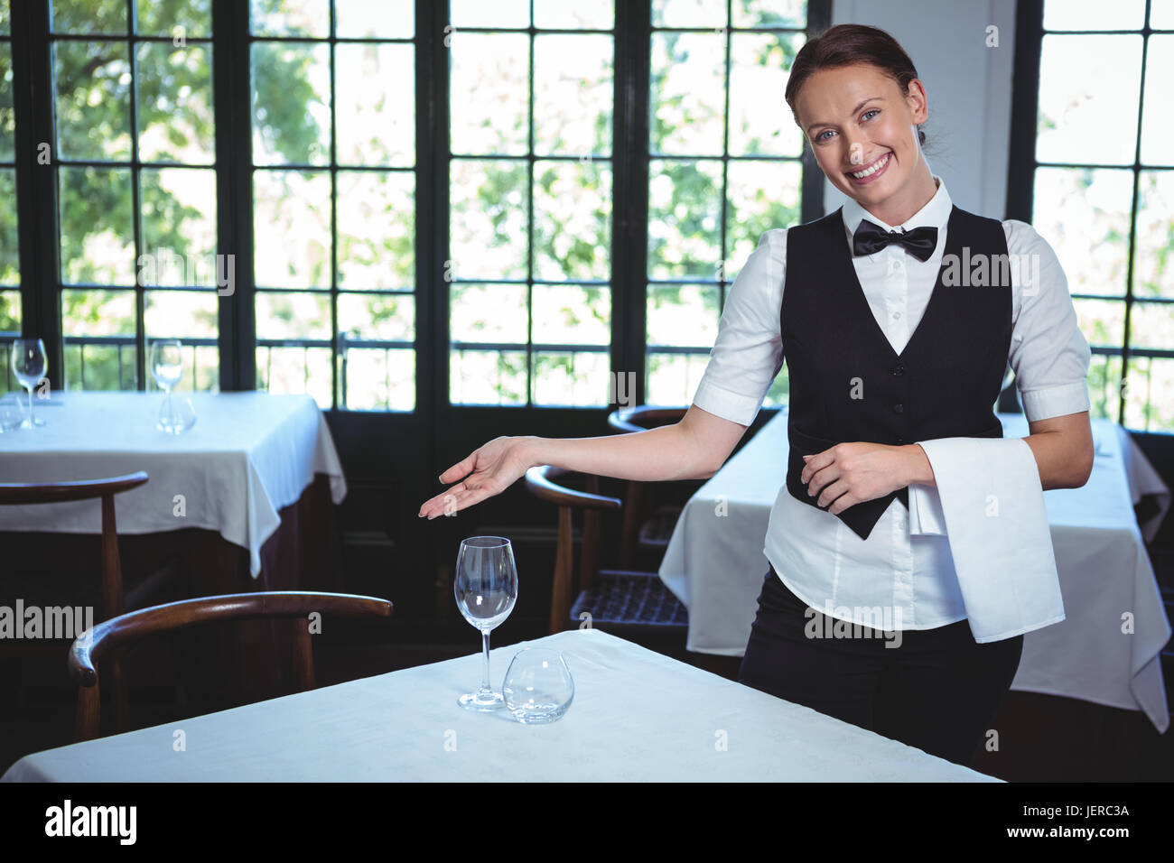 Waitress showing a table Stock Photo Alamy