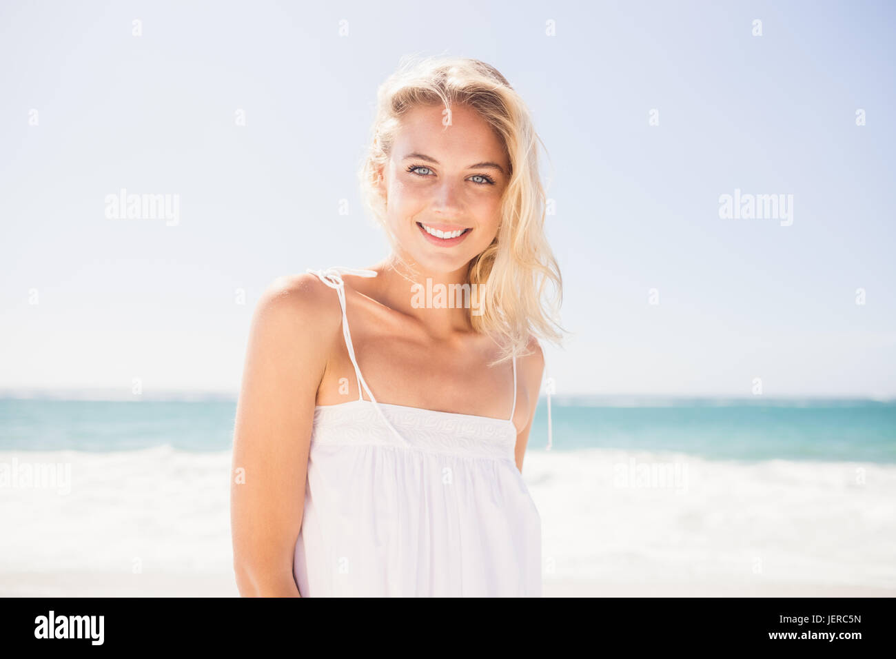 Smiling young blonde woman waves hi-res stock photography and images ...