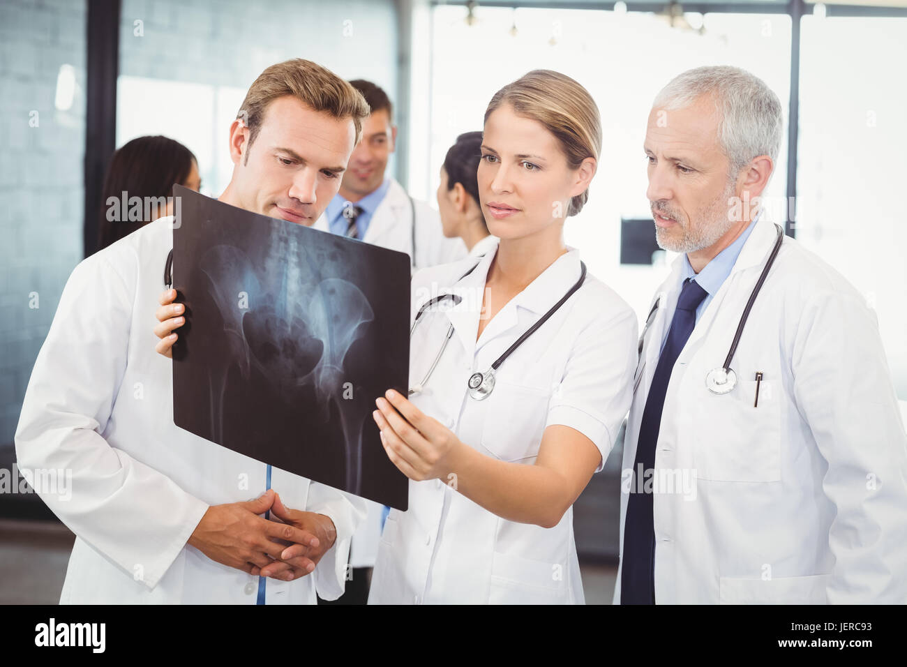Medical Team Examining An X Ray Report High Resolution Stock ...