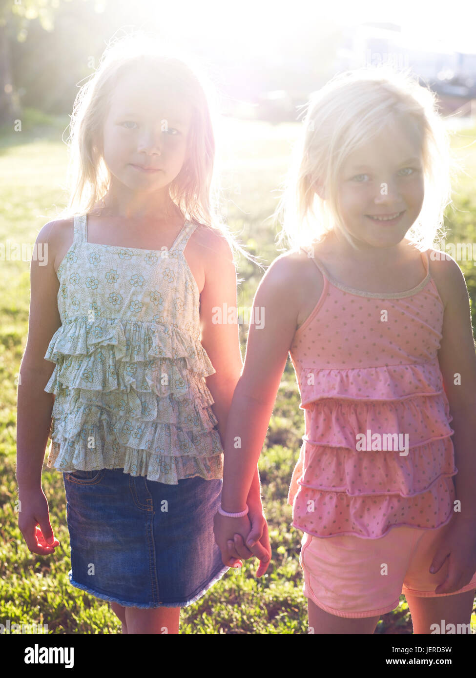 Girls holding hands Stock Photo - Alamy