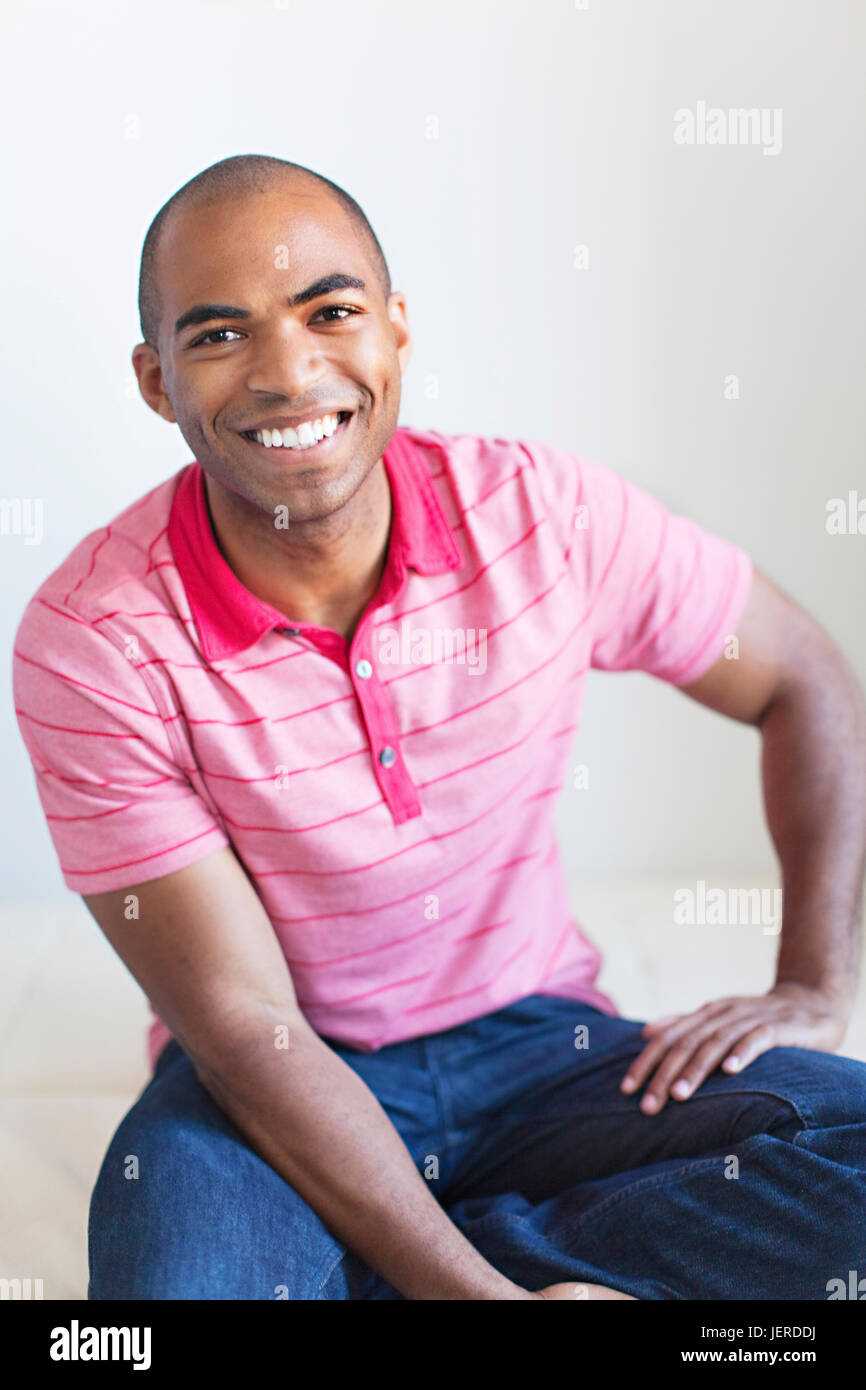 Smiling young man looking at camera Stock Photo - Alamy
