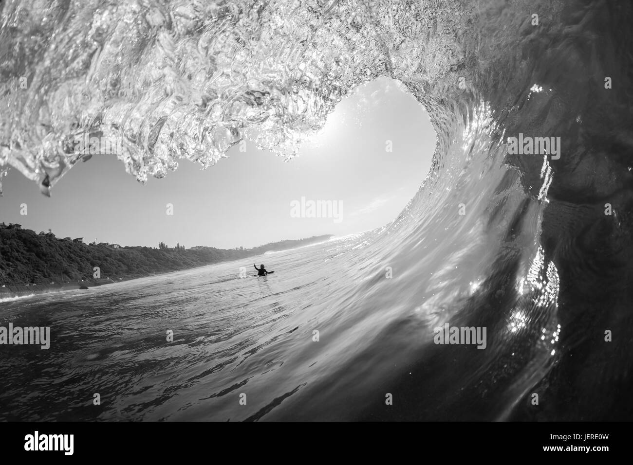 Wave surfer tube ride view swimming inside out water ocean black and white photo Stock Photo