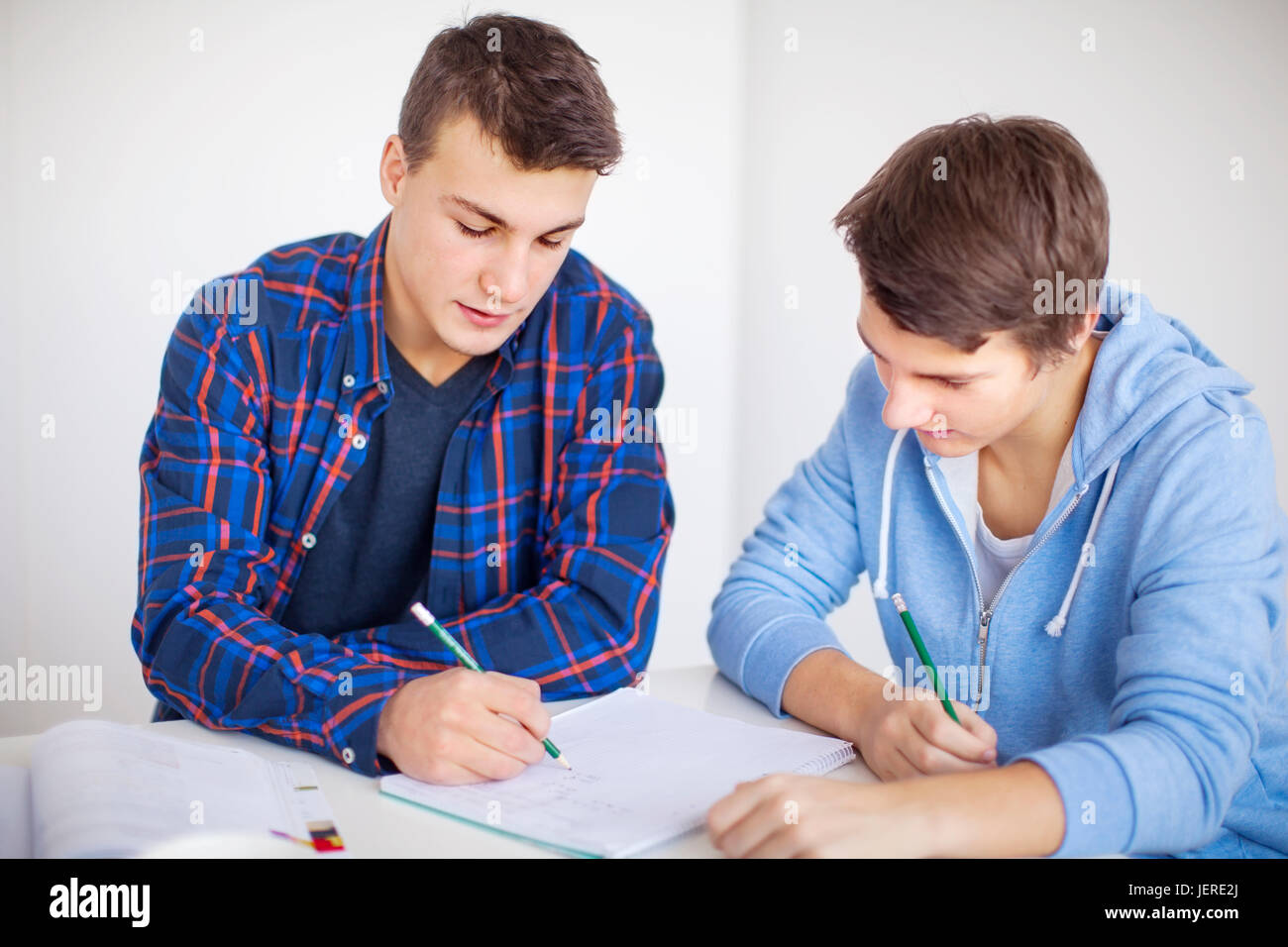 Teenage boys doing homework Stock Photo - Alamy