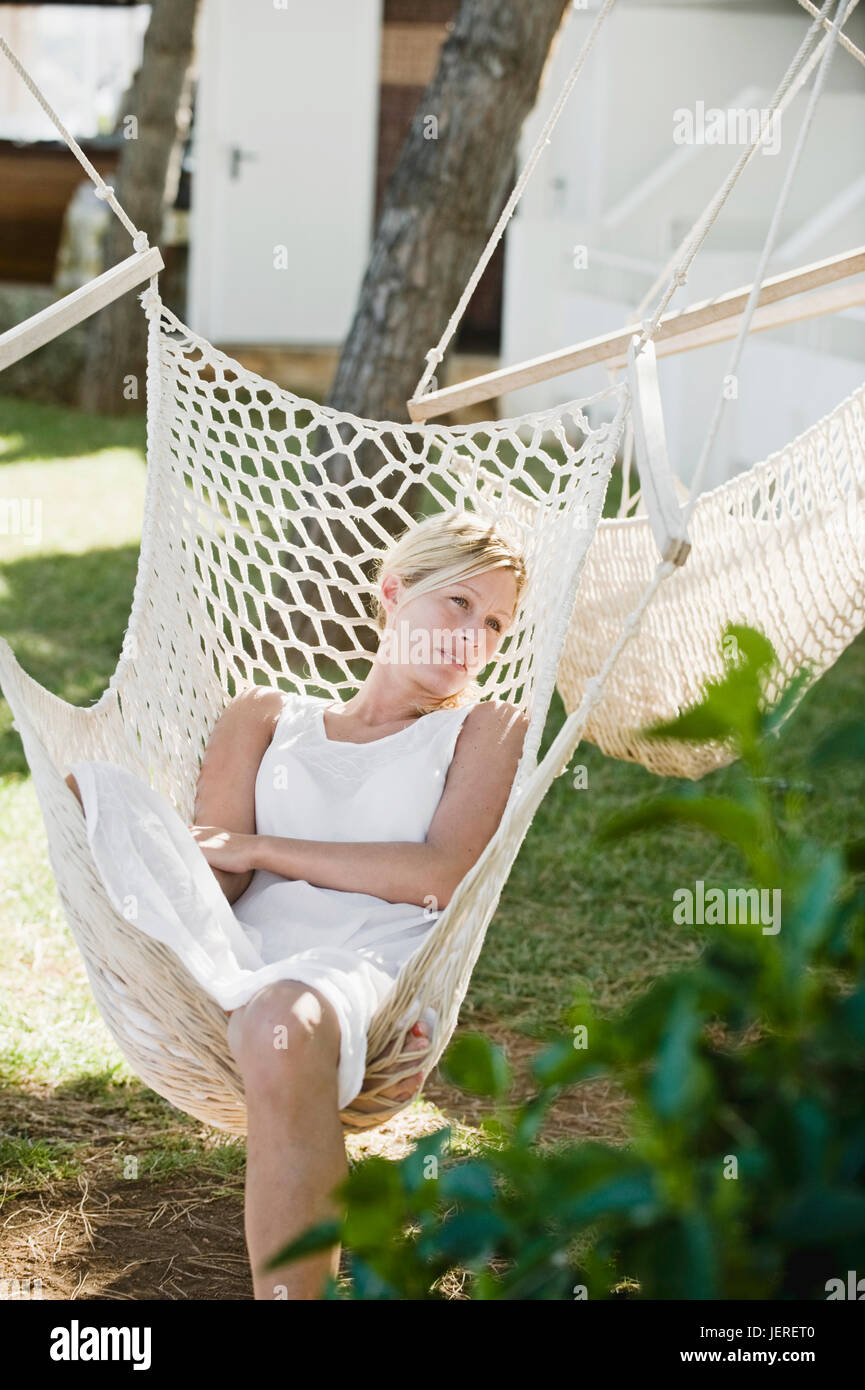 Woman relaxing in hammock Stock Photo - Alamy