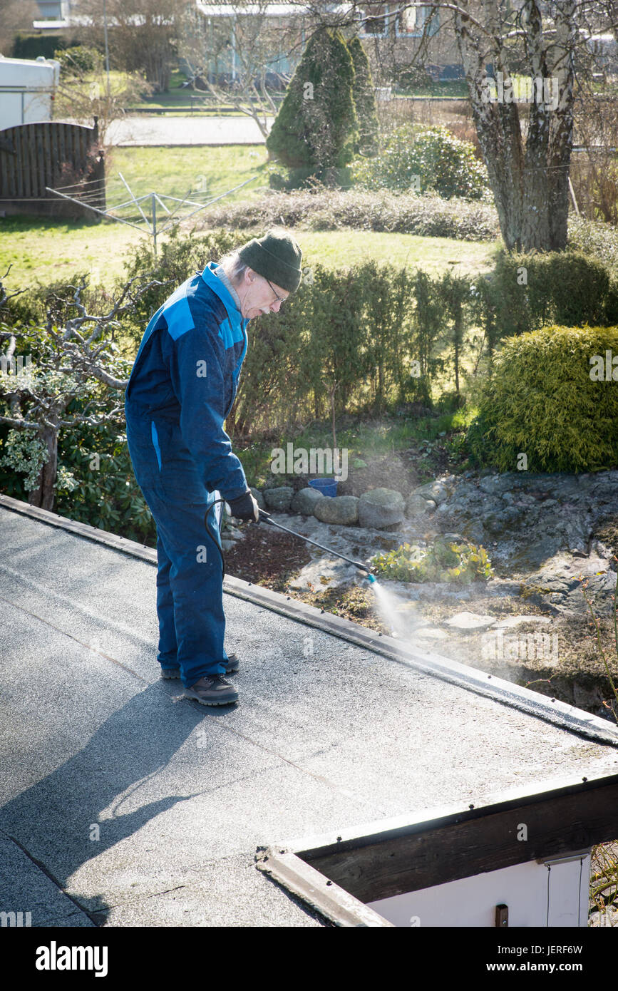 Man clearing roof Stock Photo