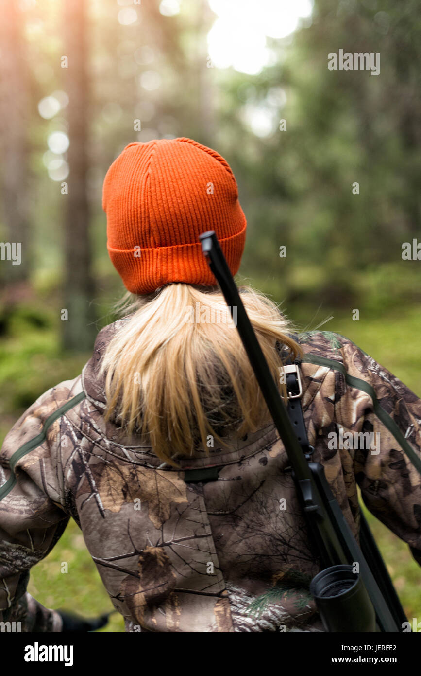 Woman hunting in forest Stock Photo