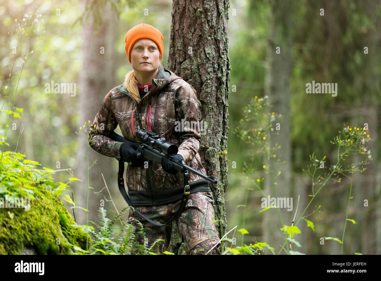 Woman hunting in forest Stock Photo