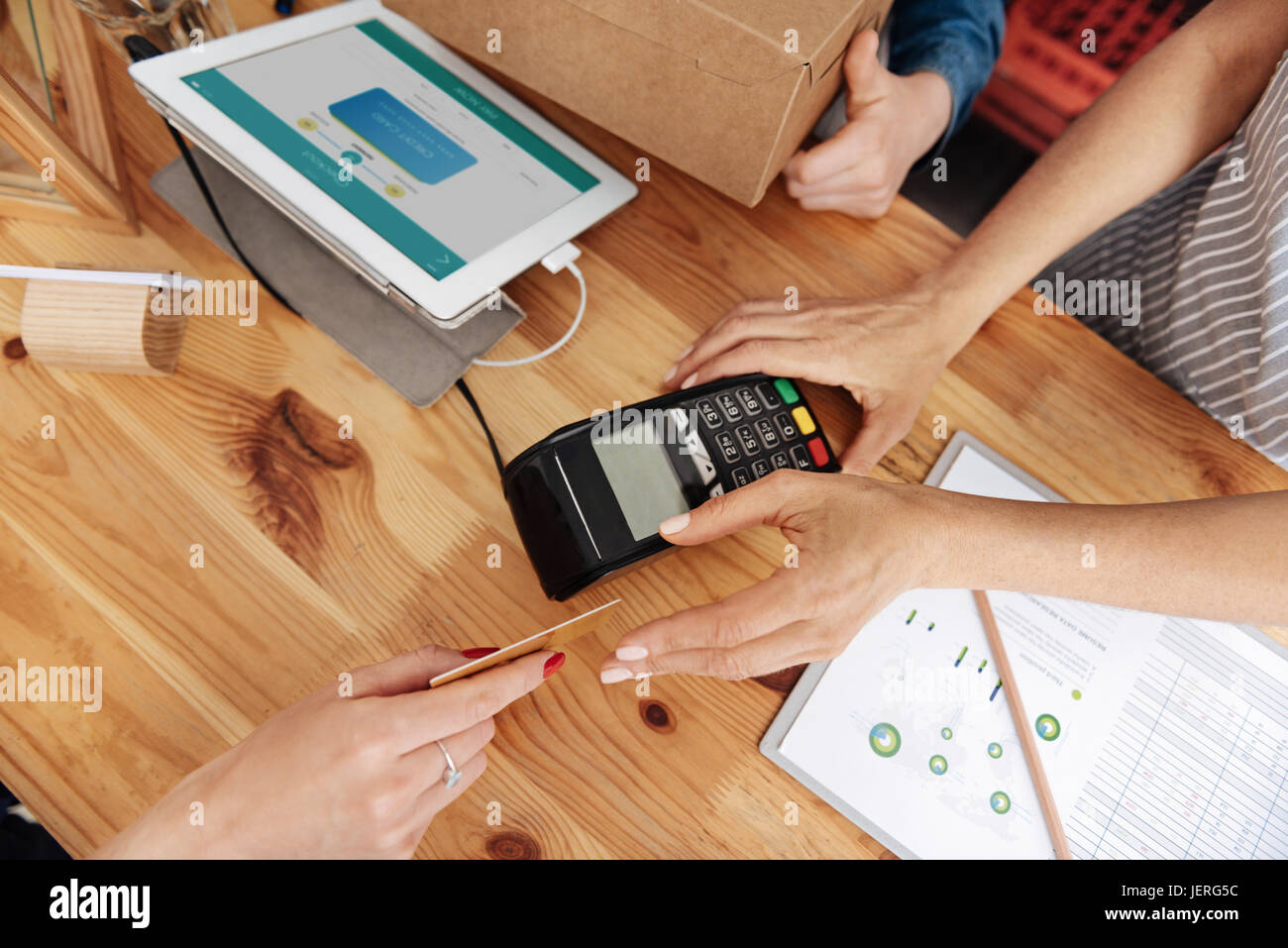 Female hands using a credit card terminal Stock Photo - Alamy