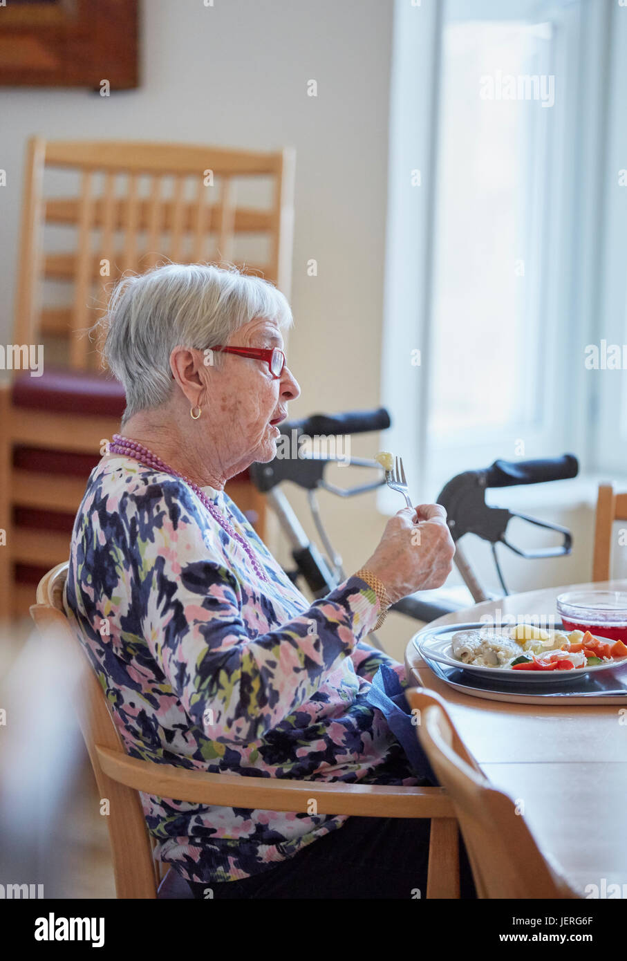 Senior woman having lunch Stock Photo