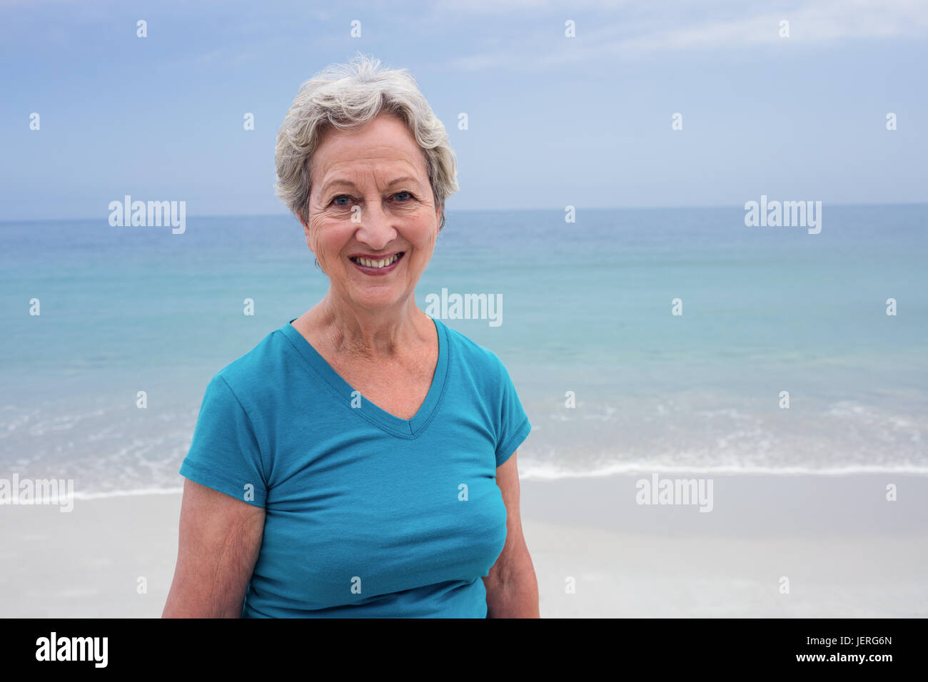 Portrait of happy senior woman on beach Stock Photo - Alamy