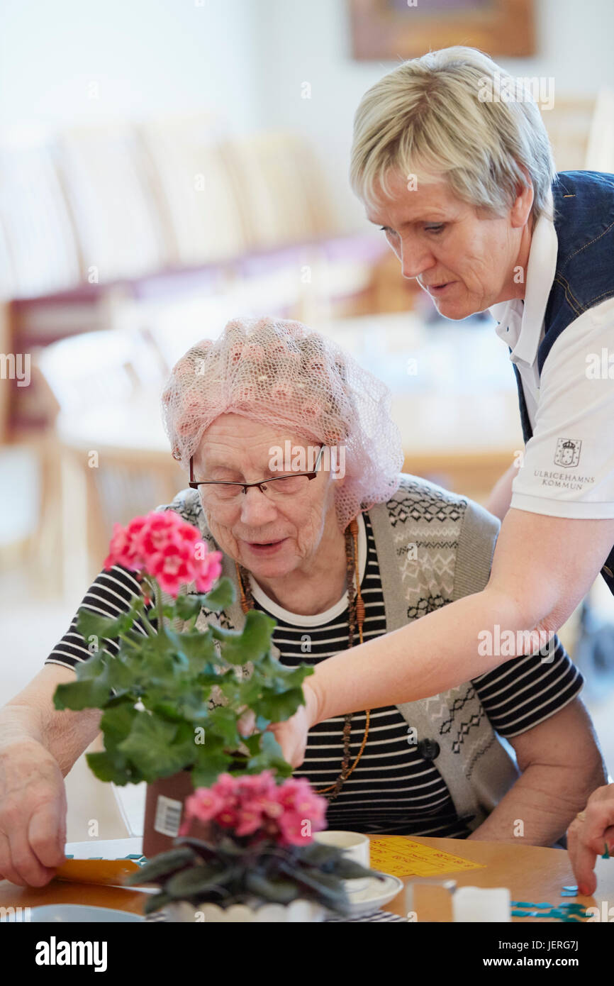 Nurse with senior woman in care home Stock Photo