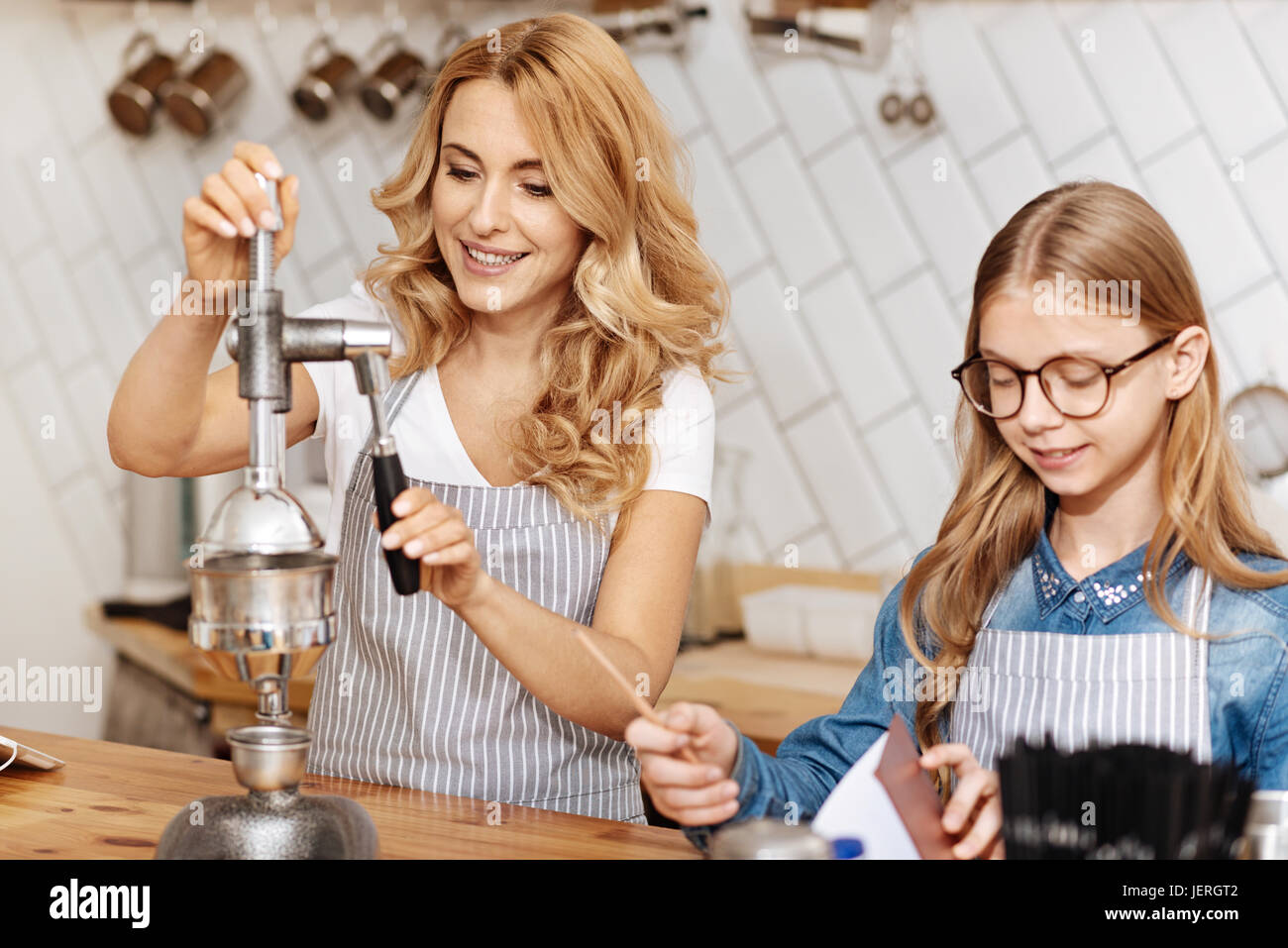 Charming barista being involved in coffeemaking process Stock Photo