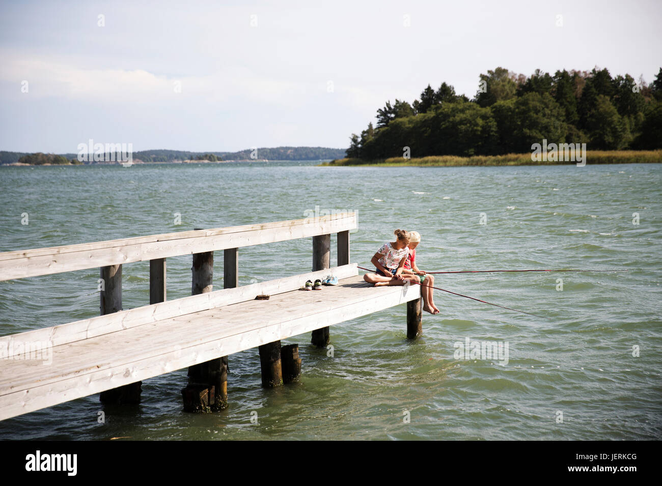 Two boys sitting fishing hi-res stock photography and images - Alamy