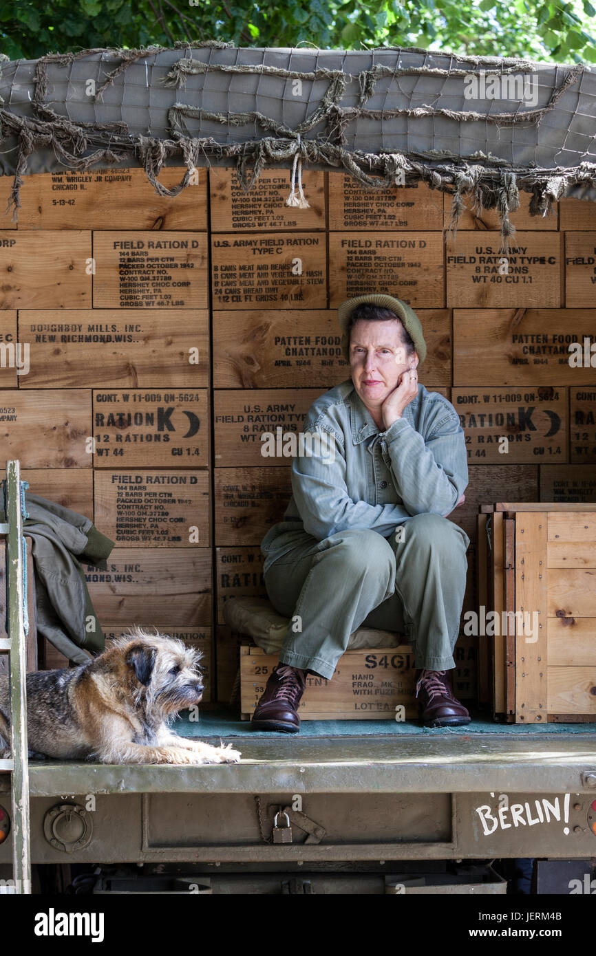 Re-enactor and Her Dog Sitting in the Back of a Truck During the 2017 Barnard Castle 1940's Weekend, County Durham, UK. Stock Photo