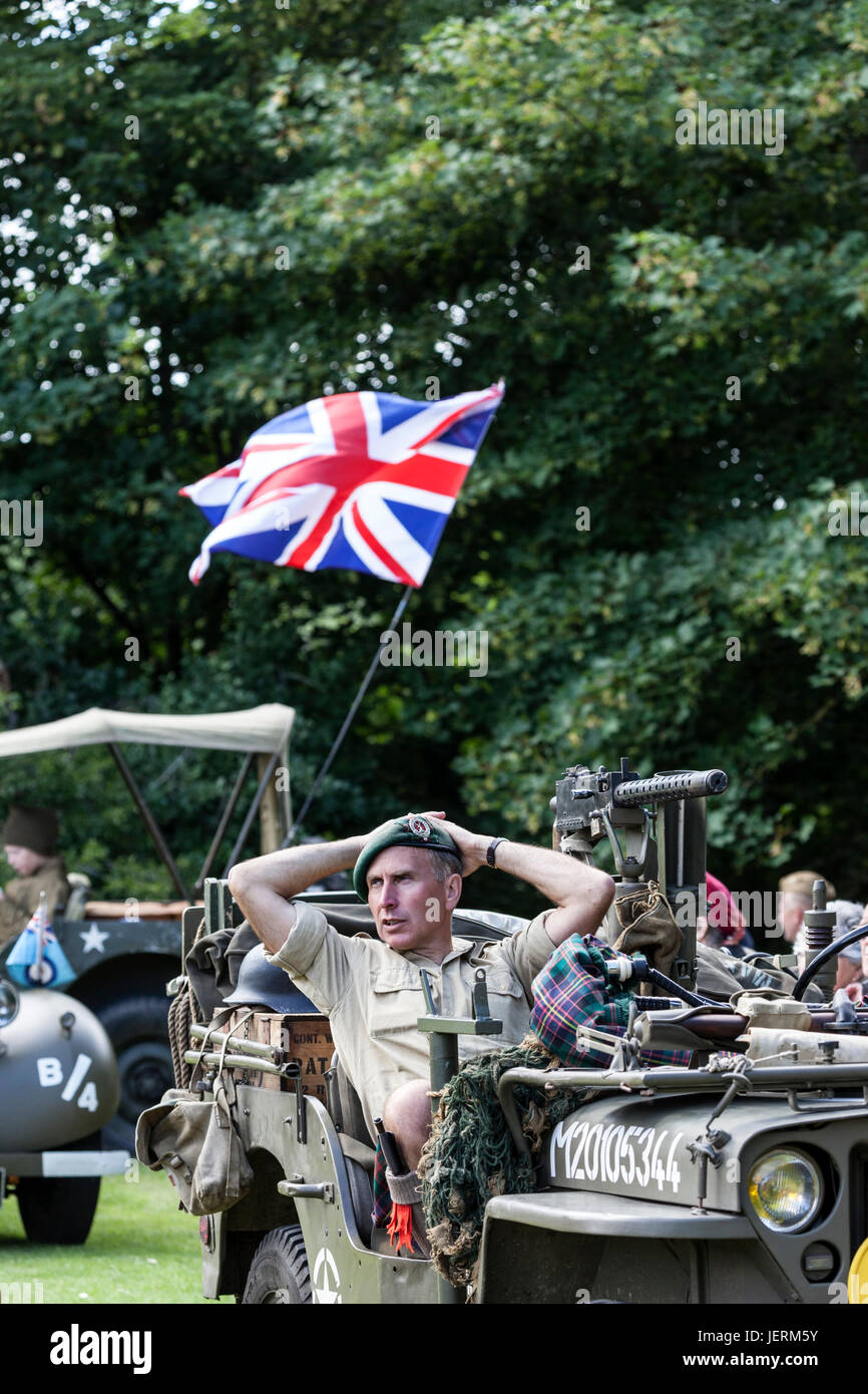 Royal Marines Commando (No 4) Resting in his Jeep With the Union Jack Flag Flying Behind, 2017 Barnard Castle 1940's Weekend, County Durham, UK. Stock Photo