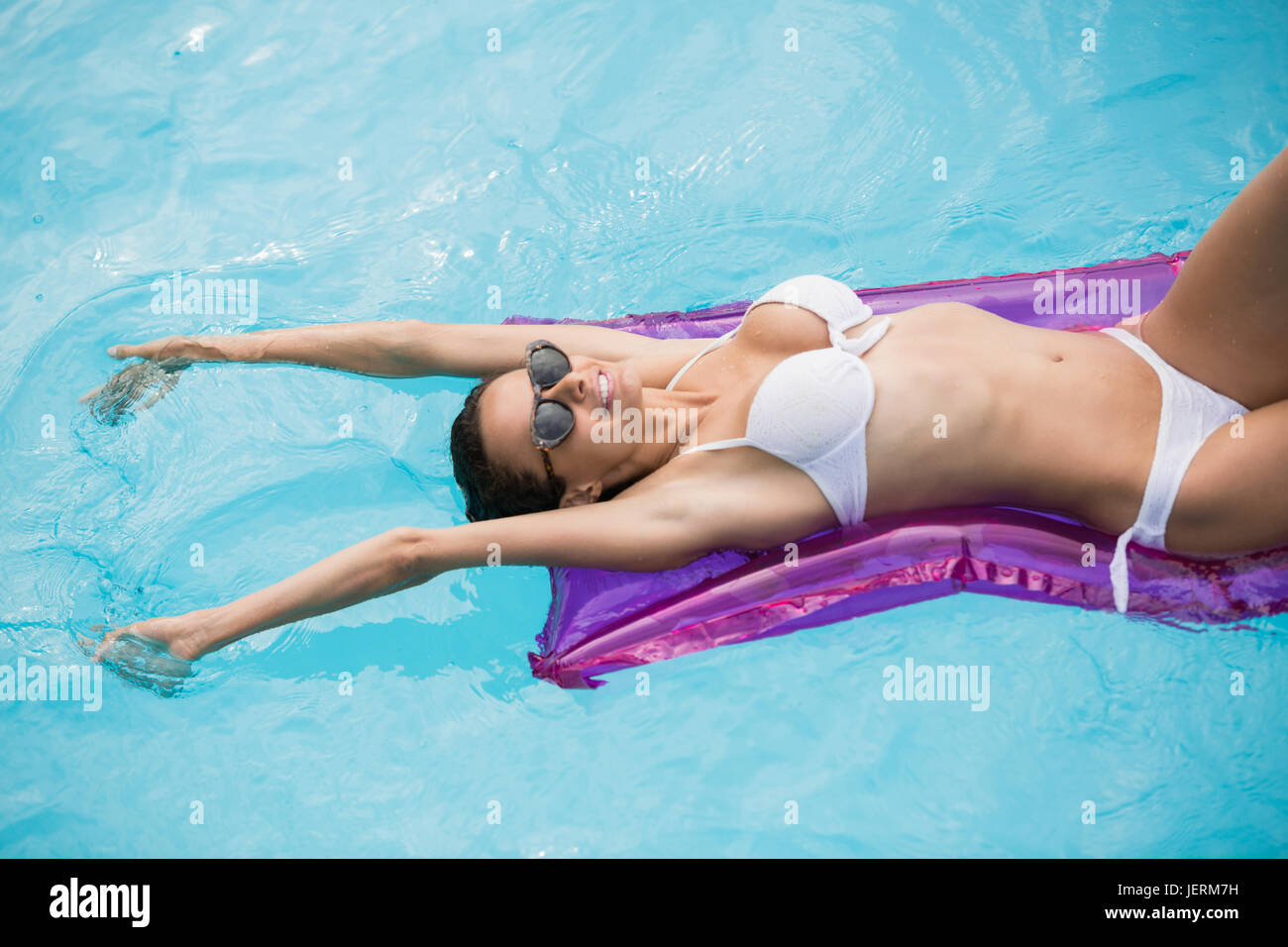 Woman relaxing on inflatable raft Stock Photo