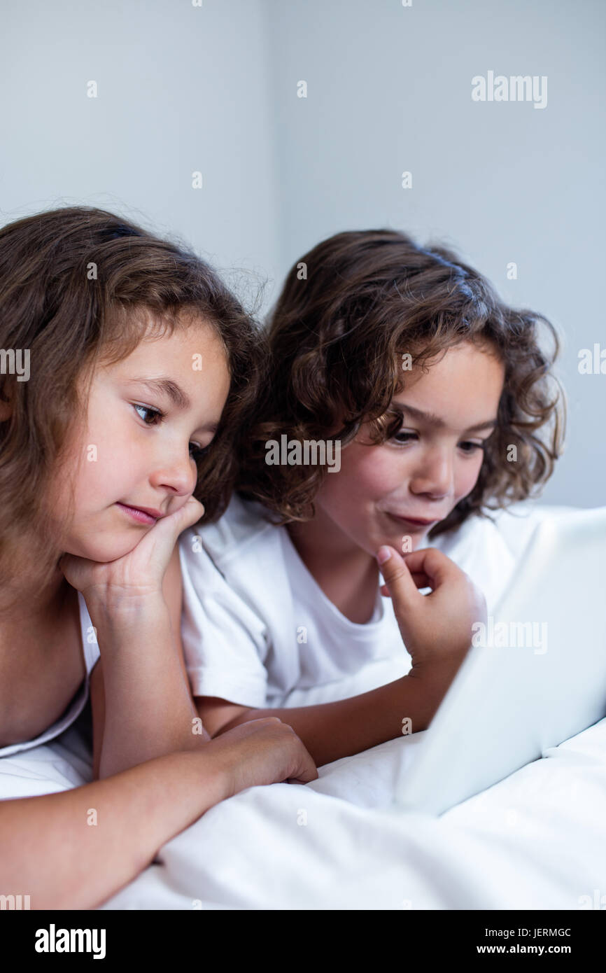 Brother and sister using digital tablet Stock Photo - Alamy