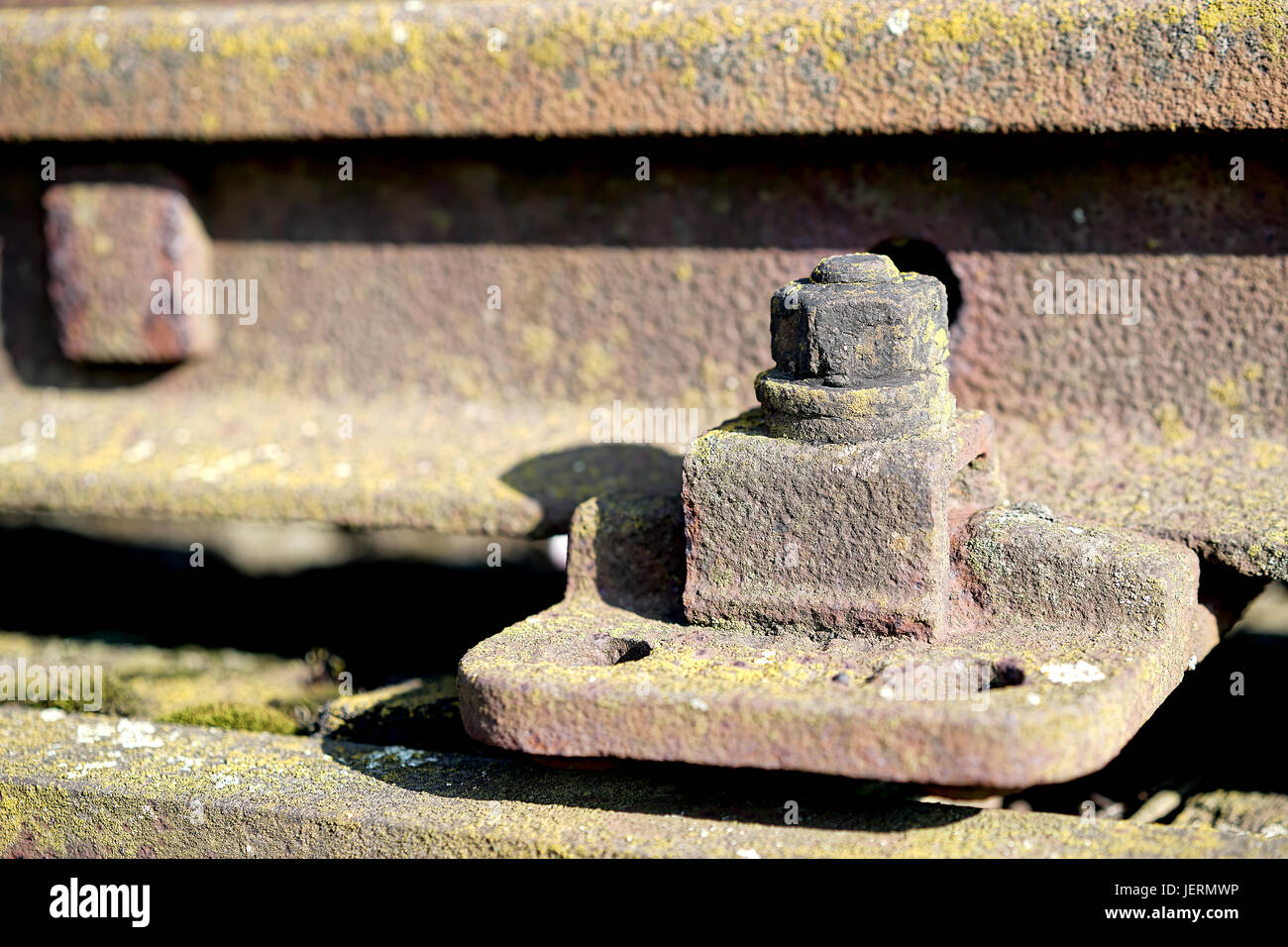 old rusty screw on a railway track Stock Photo