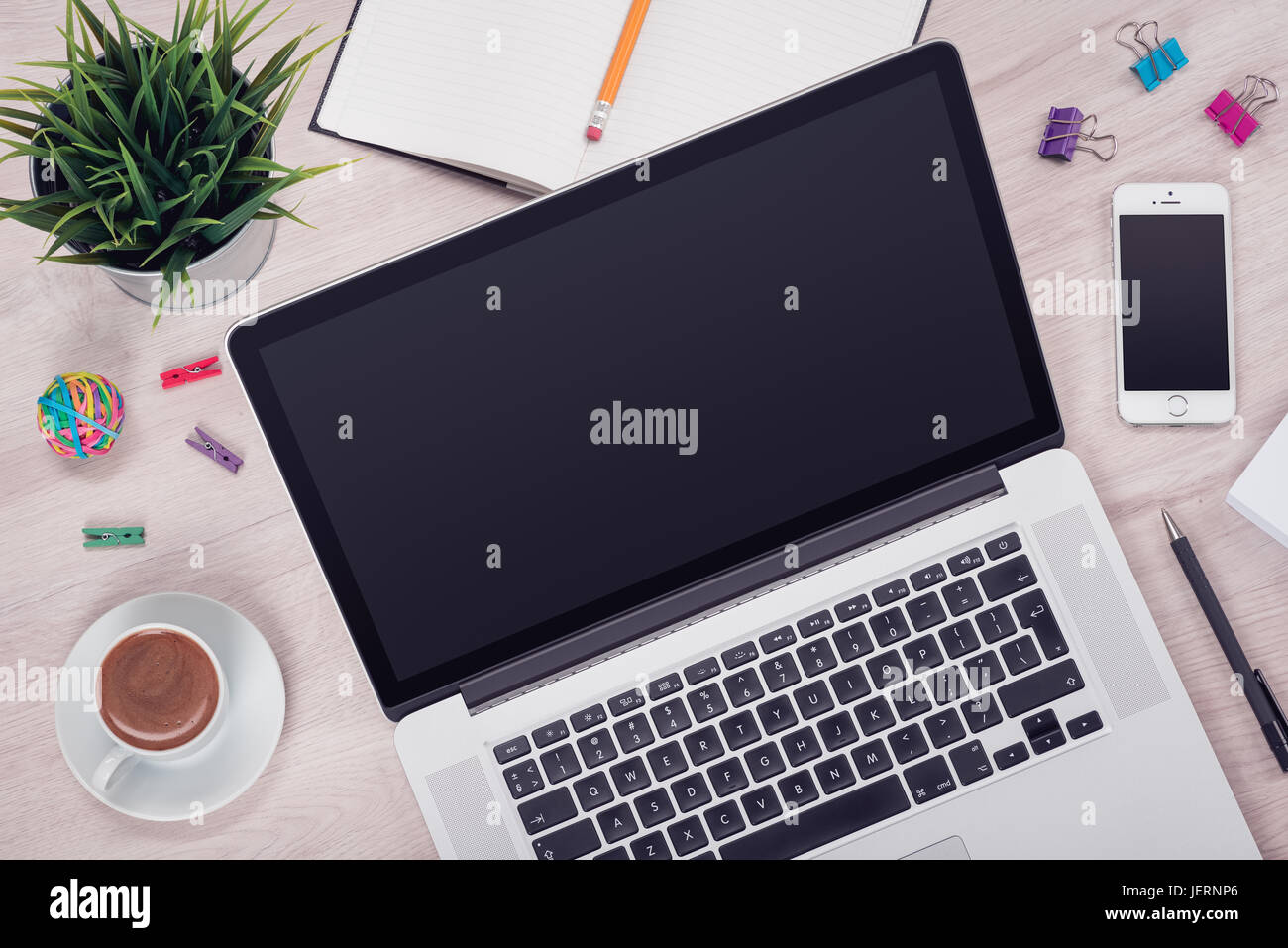 Workplace with open laptop on the office desk top view Stock Photo