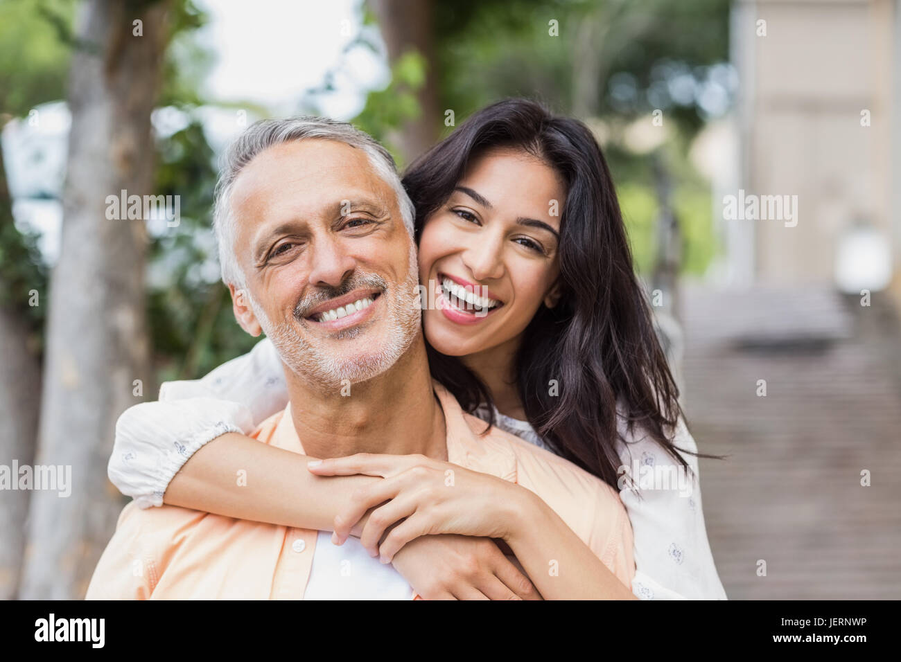 Woman embracing man from behind Stock Photo