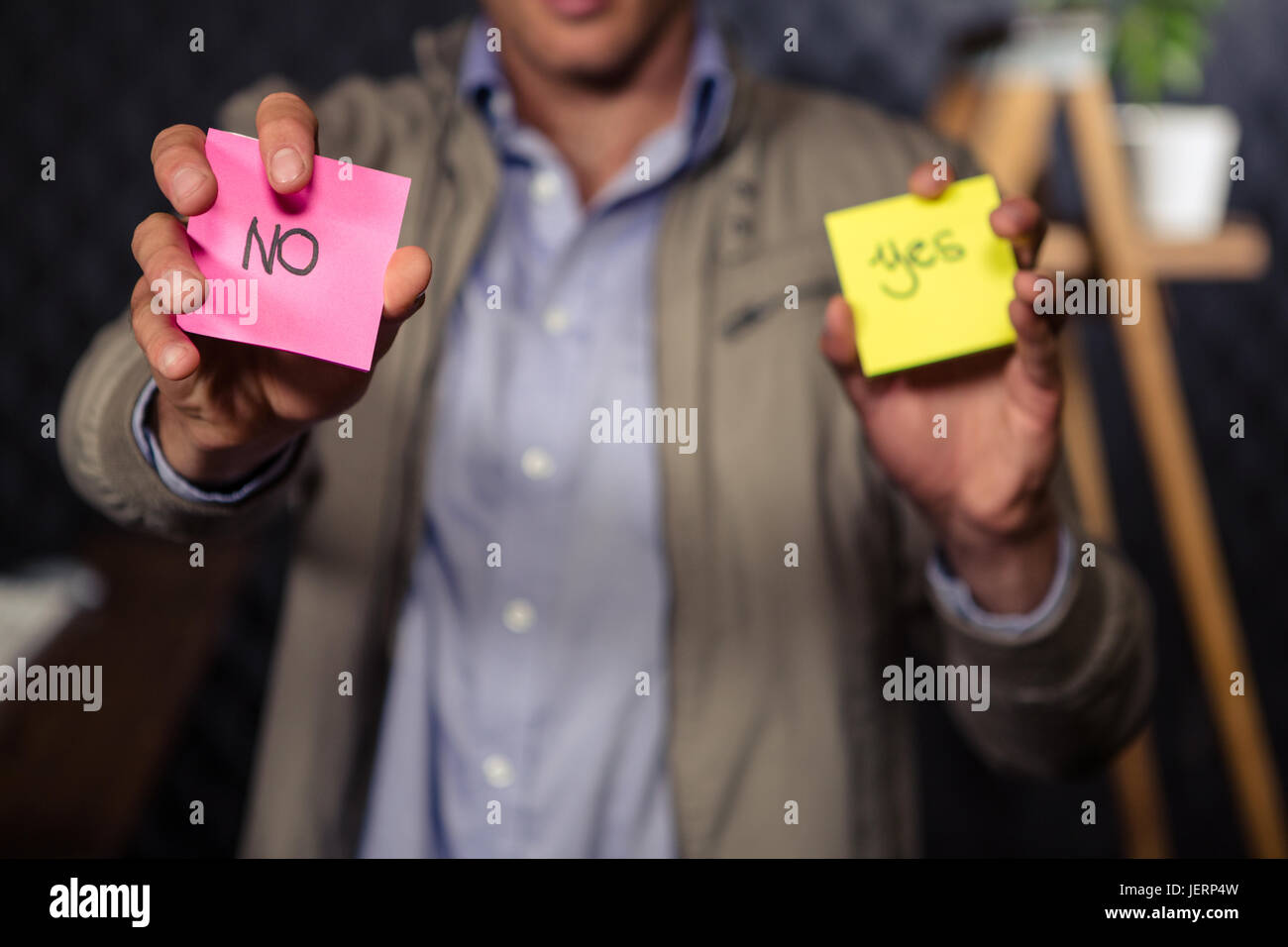 Creative businessman holding sticky notes Stock Photo - Alamy