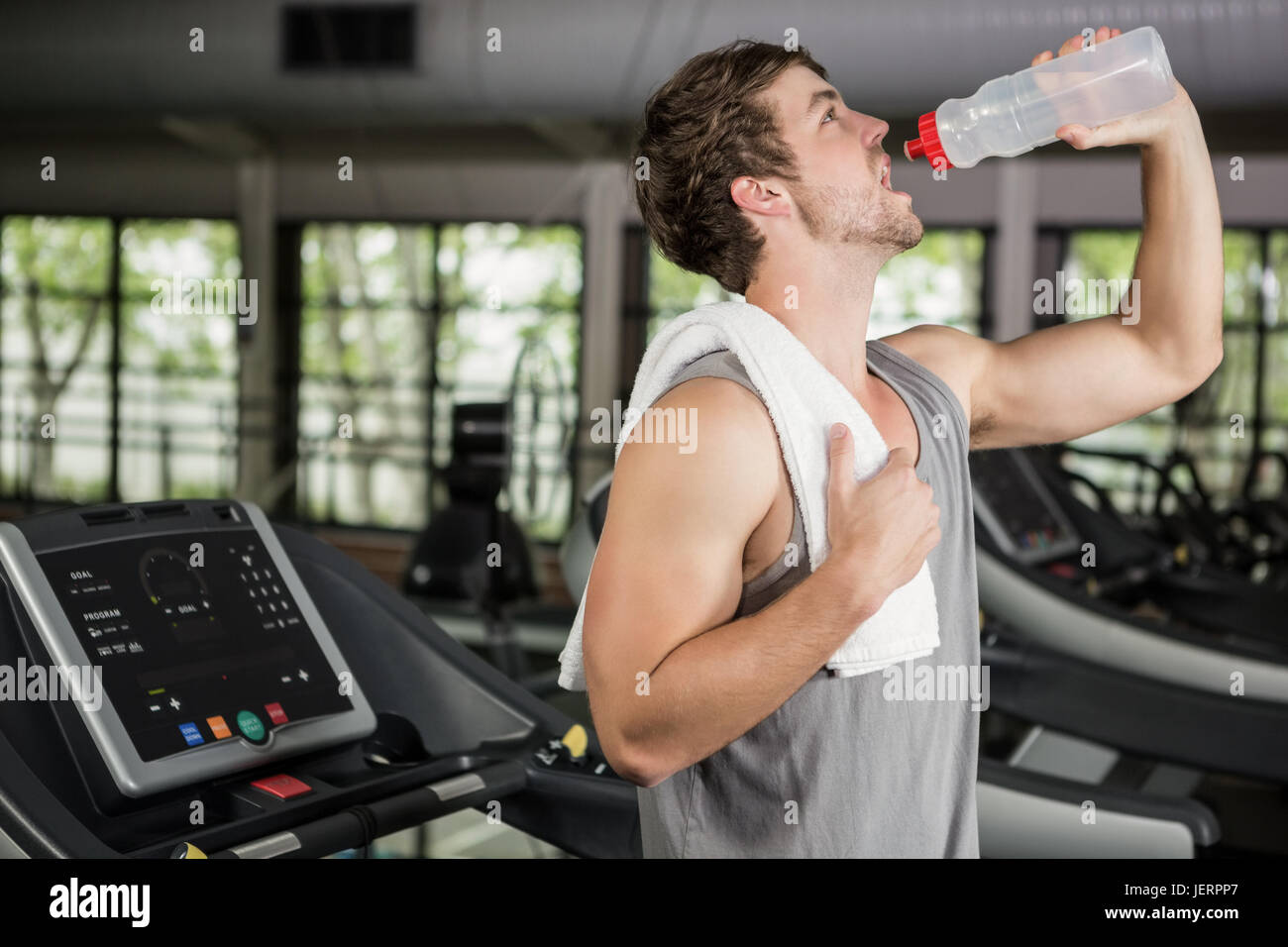 Man on treadmill drinking water at gym Stock Photo Alamy